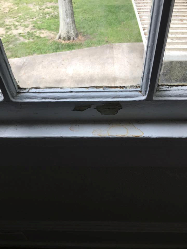 Cracked and peeling paint is seen on a windowsill of the duplex where the Price family lived on Gillis W. Long National Guard Center in Carville